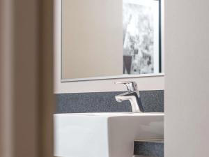 a bathroom with a sink and a mirror at Novotel Santiago Las Condes in Santiago +93 photos
