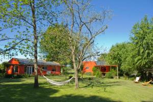 a house with a hammock in a yard with trees at Finca El Encuentro in Campana