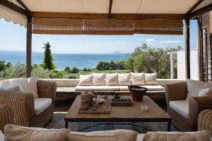 a living room with a couch and a table at Liogerma Boutique Home in Skiathos
