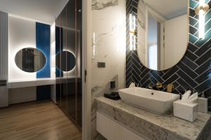 a bathroom with a sink and two mirrors at Above Element Bangtao Phuket by Arthouse Collection in Laguna Phuket +27 photos