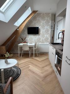 a kitchen with a table and a dining room at Léonie-Les appart's de Léon in Landerneau