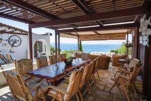 a wooden table and chairs on a patio at Liogerma Boutique Home in Skiathos
