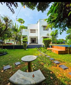 a white house with a table in the yard at solomons ark luxury pool villa in Cochin
