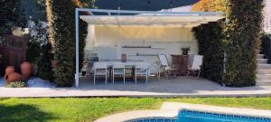 a patio with a table and chairs and a pool at Casa El Castañal con Piscina Privada in Vigo