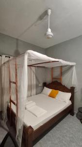 a bedroom with a bunk bed with a canopy at Zai Homes Watamu in Watamu