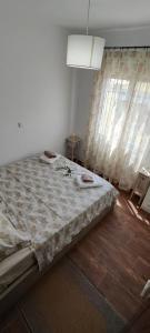 a large bed in a room with a window at Dafnonas House - Bright & Modern in Leonidio
