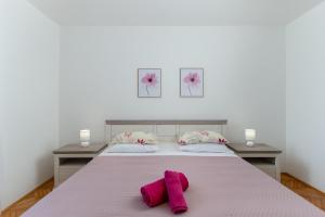 a bed with two pink towels on top of it at House FELICIA in Kršan +31 photos