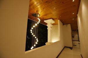 a bathroom with a toilet with lights on the wall at J Hotel in Jaffna