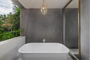a white bath tub in a bathroom with a window at Ishq Digana in Digana