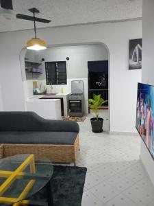 a living room with a couch and a table at TN Apartments Adina in Diani Beach