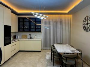 a kitchen and dining room with a table and chairs at Villa Luxury Forest in Peje