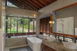 a bathroom with two sinks and a large mirror at Ishq Digana in Digana