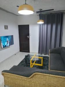 a living room with a couch and a table at TN Apartments Adina in Diani Beach