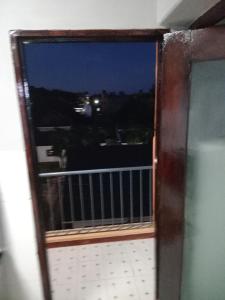 a view from a window of a balcony at night at TN Apartments Adina in Diani Beach