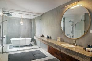 a bathroom with a tub and a sink and a mirror at Ishq Digana in Digana +62 photos
