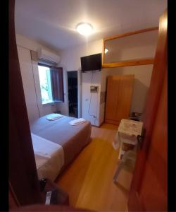 a small room with a bed and a table in it at Maras in Palinuro