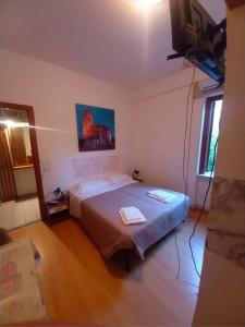 a bedroom with a bed and a flat screen tv at Maras in Palinuro