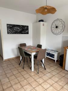 a kitchen with a table and chairs in a room at La Tranche Cozy Stay! in La Tranche-sur-Mer