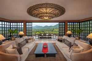 a living room with a large couch and a table at Ishq Digana in Digana