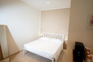 a bedroom with a white bed in a room at Locanda dell Angelo in Piacenza