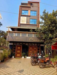 a building with motorcycles parked in front of it at royal galaxy hotel in Durgāpur