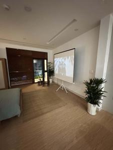 a living room with a large screen in the wall at Ceilé Stay Đà Lạt in Da Lat