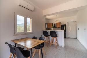 a kitchen and dining room with a wooden table and chairs at Villa Pasiphae by PosarelliVillas in Vamos