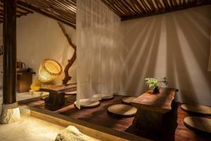a room with tables and chairs and a curtain at ZenHome by M2 in Hoi An