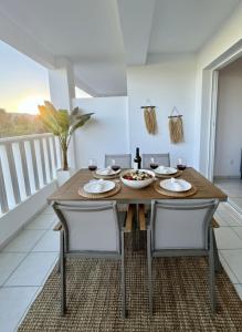 a dining room with a wooden table and chairs at Polis Gardens Pool Apartment in Polis Chrysochous