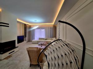 a living room with a couch and a chair at Villa Luxury Forest in Peje