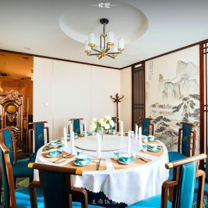 a dining room with a table with blue chairs at Royal House Hotel in Ulaanbaatar