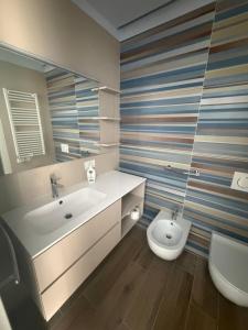 a bathroom with a sink and a toilet at Vale House in Monopoli