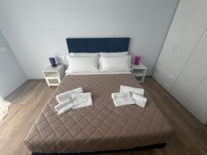 a bedroom with a large bed with two pillows at Vale House in Monopoli +11 photos
