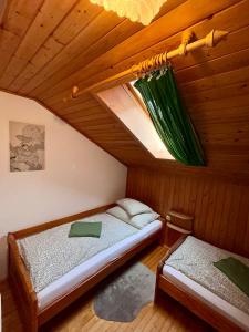 a bedroom with two beds in a wooden room at Pferdehof Almgut - Reiten für Kinder, Natur und Erholung nahe Salzburg in Faistenau