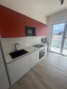 a kitchen with a sink and a microwave at Vale House in Monopoli