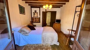 a bedroom with a bed with a blue comforter at Casa Pueblo Anibal in Fermoselle