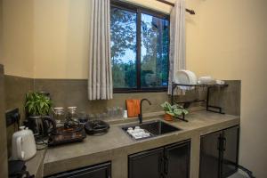 a kitchen counter with a sink and a window at Hill Top Legacy in Ambalangoda