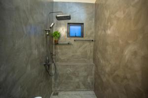 a shower stall with a window in a bathroom at Hill Top Legacy in Ambalangoda