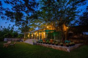 a house with lights on it in a yard at Hill Top Legacy in Ambalangoda