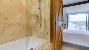 a bathroom with a shower and a bath tub at Thalassa in Cemaes Bay +35 photos