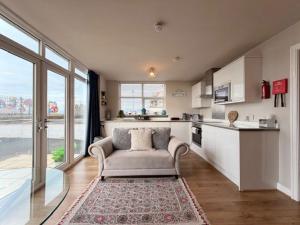 a living room with a couch and a kitchen at Stay in Blackpool