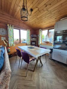 a dining room with a table and some chairs at 3-Bed Ocean View Lodge - Parking & Terrace in Ilfracombe