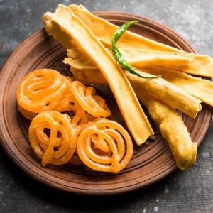 a plate of food with pretzels and chips at Lords Swastik Studio Kodinar in Kodīnar