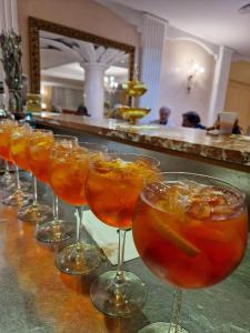 a row of wine glasses sitting on a bar at Hotel L'Aquila in Pomezia
