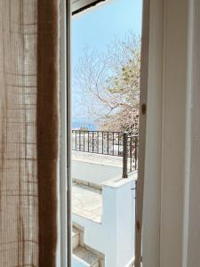 an open window with a view of a balcony at Sand & Sea II in Neo Klima +2 photos