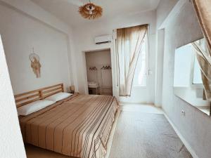 a bedroom with a large bed and a window at Sand & Sea II in Neo Klima