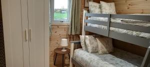 a bedroom with a bunk bed in a tiny house at Stag's View in Ballina