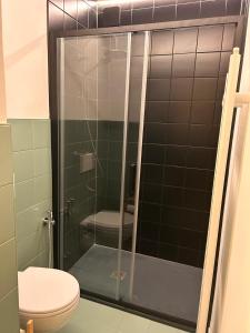 a bathroom with a glass shower with a toilet at Mi&Ti Bed&Breakfast in Vicenza