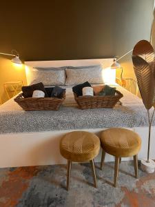 a bedroom with a bed with two ottomans and two chairs at Mi&Ti Bed&Breakfast in Vicenza