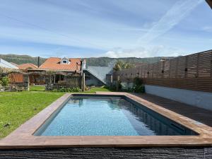 a swimming pool in the backyard of a house at Casa da Porta Amarela in Sete Cidades